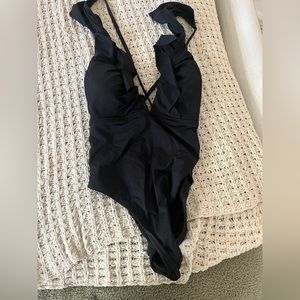 Strappy black one piece suit, size medium